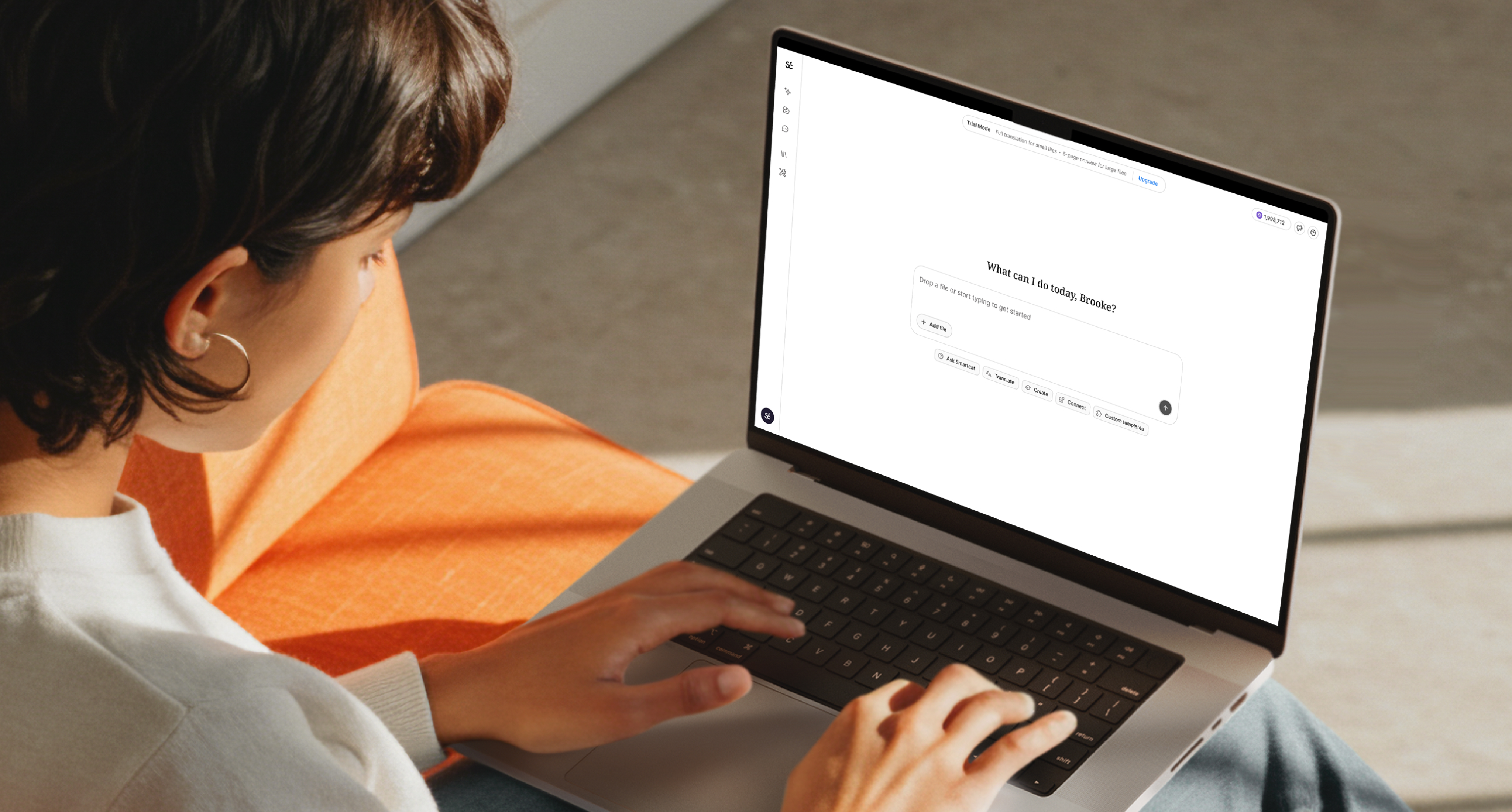 Person using a laptop with an AI assistant interface open on the screen.